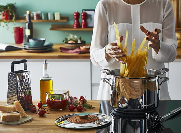 a woman is cooking pastas