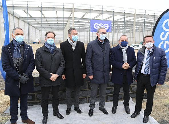 photo of 6 men in front of the low wall representing the laying of the first stone of the new Groupe SEB logistics platform in Bully-les-Mines